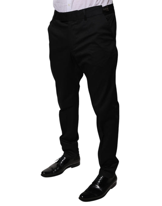 A pair of black tapered formal dress pants from the brand Dolce & Gabbana. They are made of cotton and featur