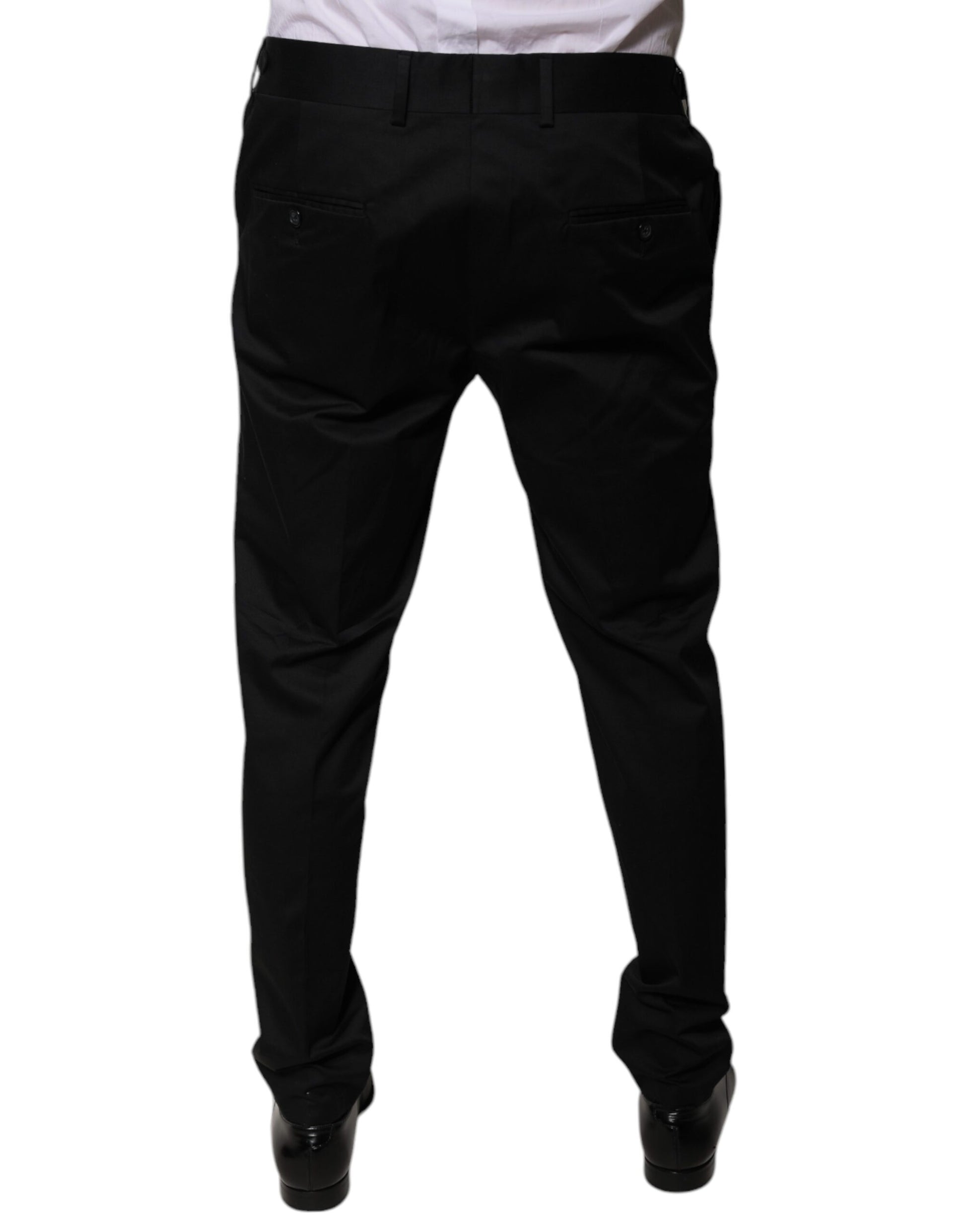 A pair of black tapered formal dress pants from the brand Dolce & Gabbana. They are made of cotton and featur