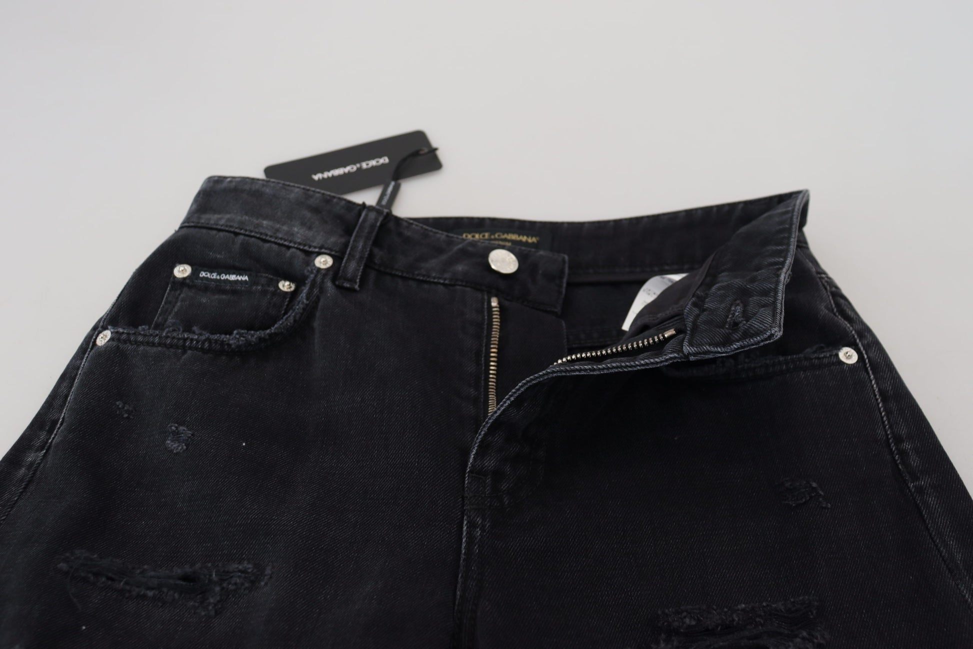 Pair of black denim jeans with zippered pockets