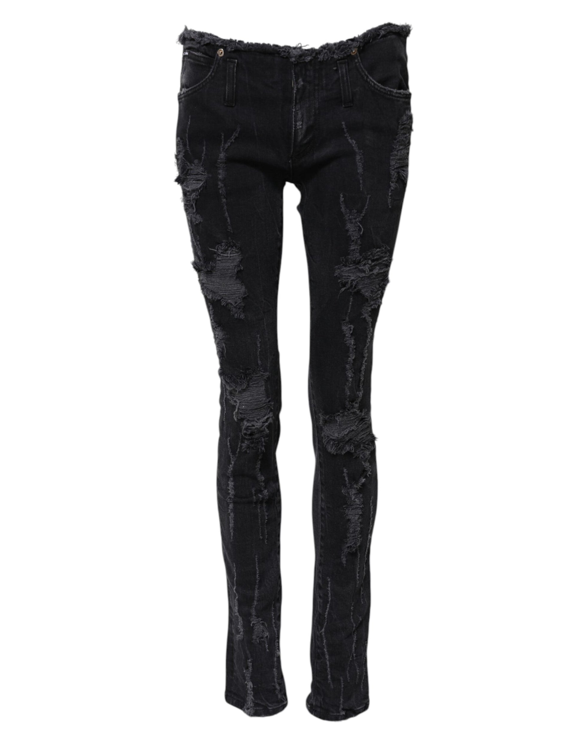 Pair of black skinny jeans with distressed design on legs
