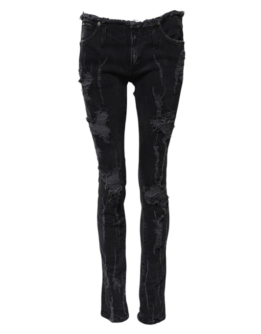 Pair of black skinny jeans with distressed design on legs