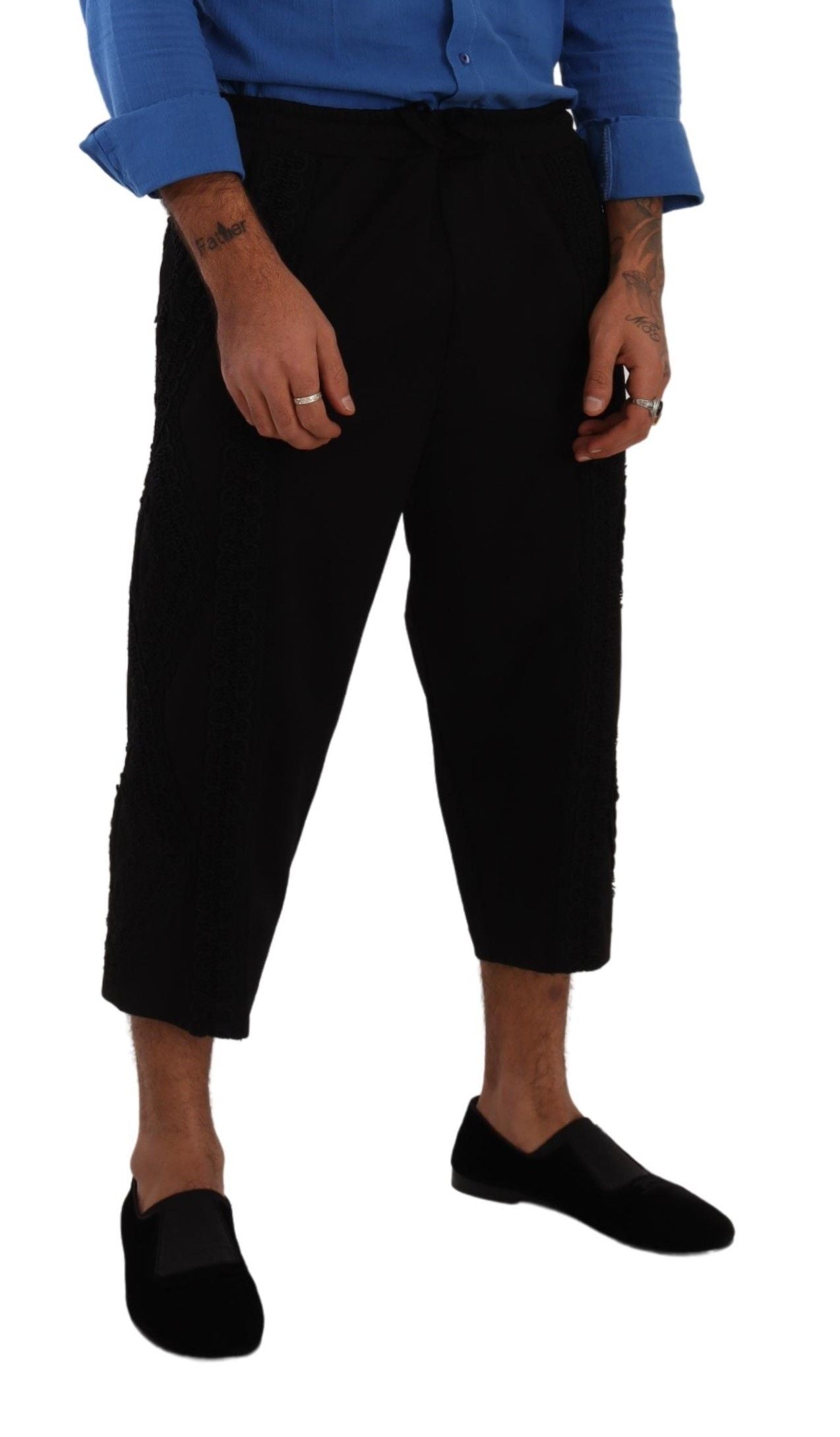 Man wearing black pants and blue shoes