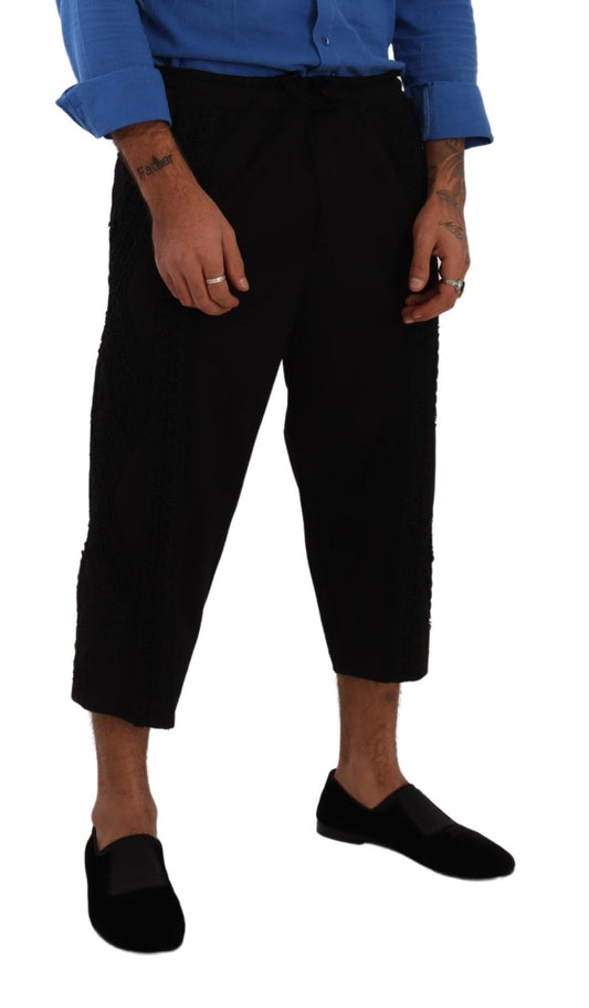 Man wearing black pants and blue shoes