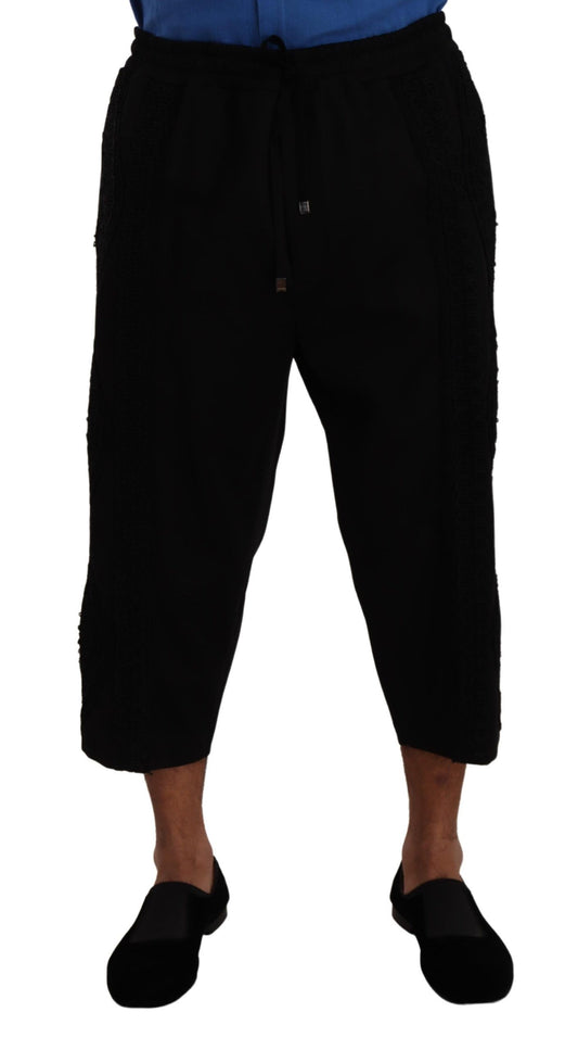 Pair of black pants with rolled up legs