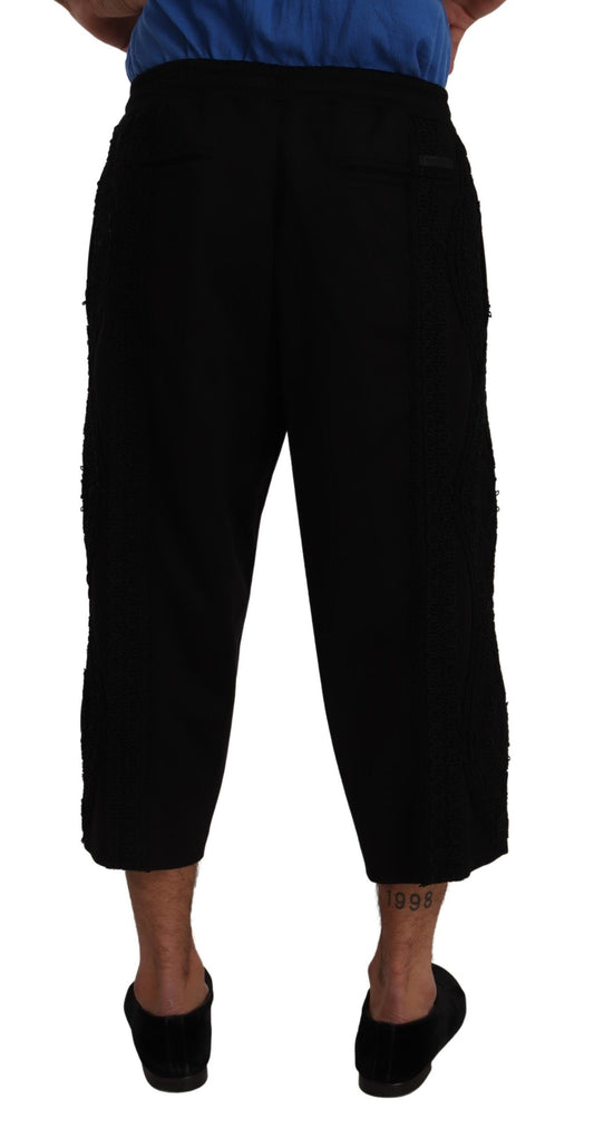 Pair of black pants with rolled up legs