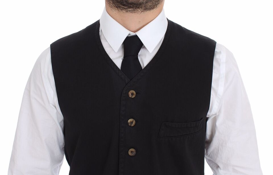 A black vest with a white shirt underneath, featuring a collar and buttons