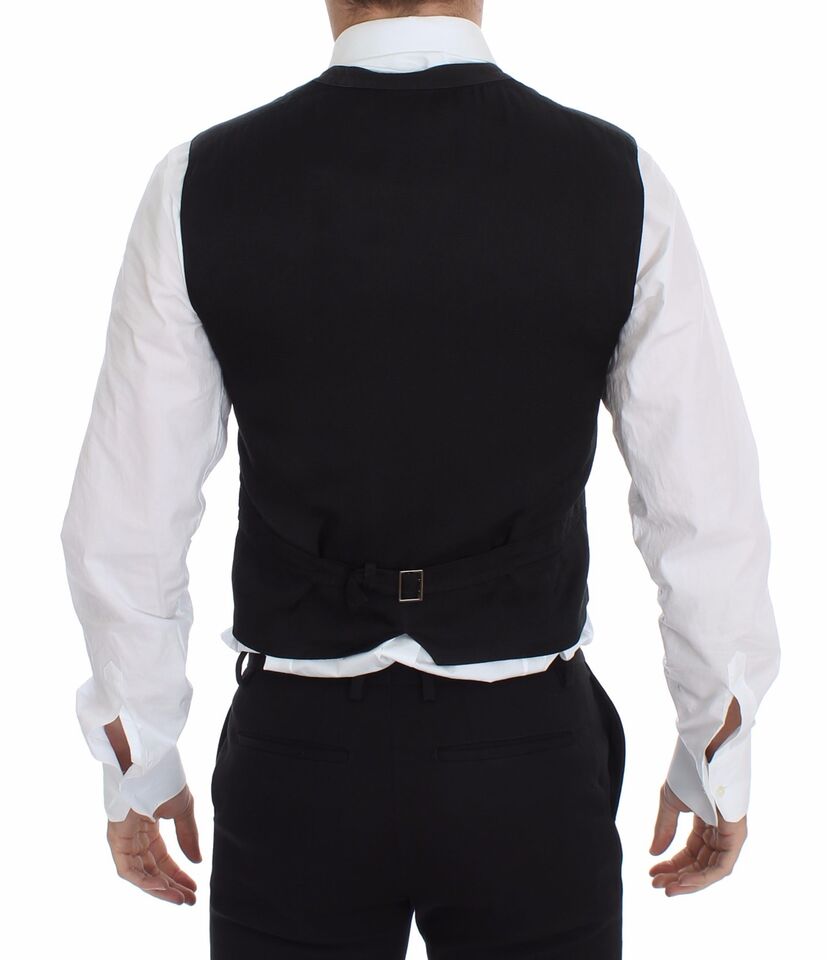A black vest with a belt and buckle, part of a formal suit
