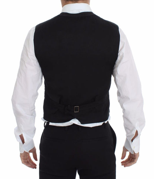 A black vest with a belt and buckle, part of a formal suit