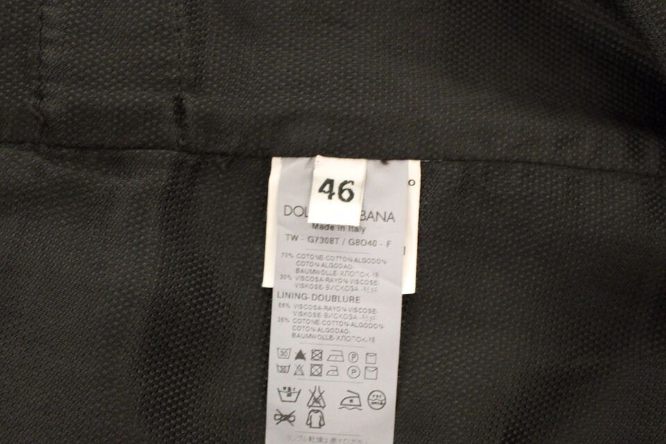 A black cotton viscose dress vest blazer with a label indicating it is from Dolce & Gabbana