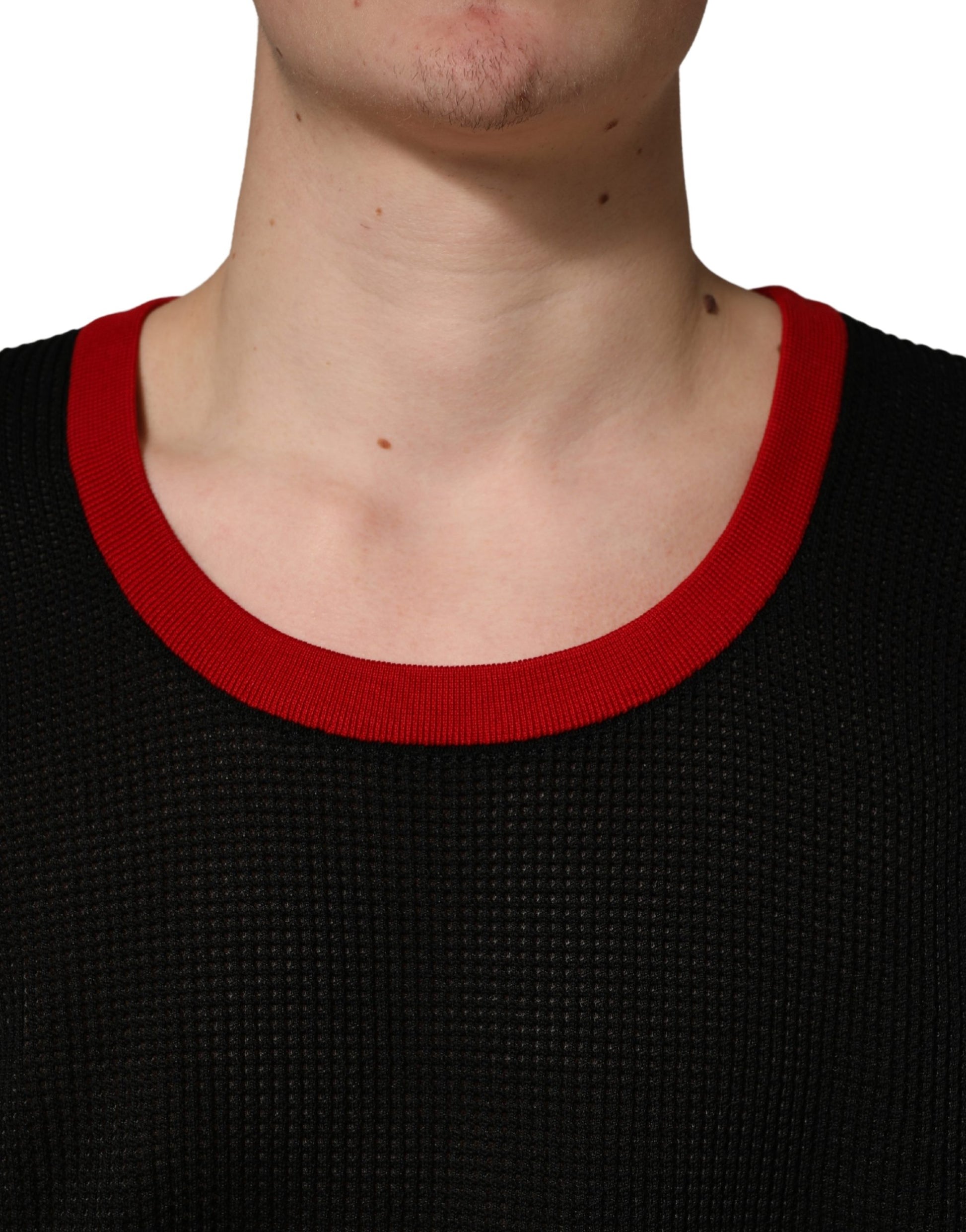 Man wearing black sweater with red trim