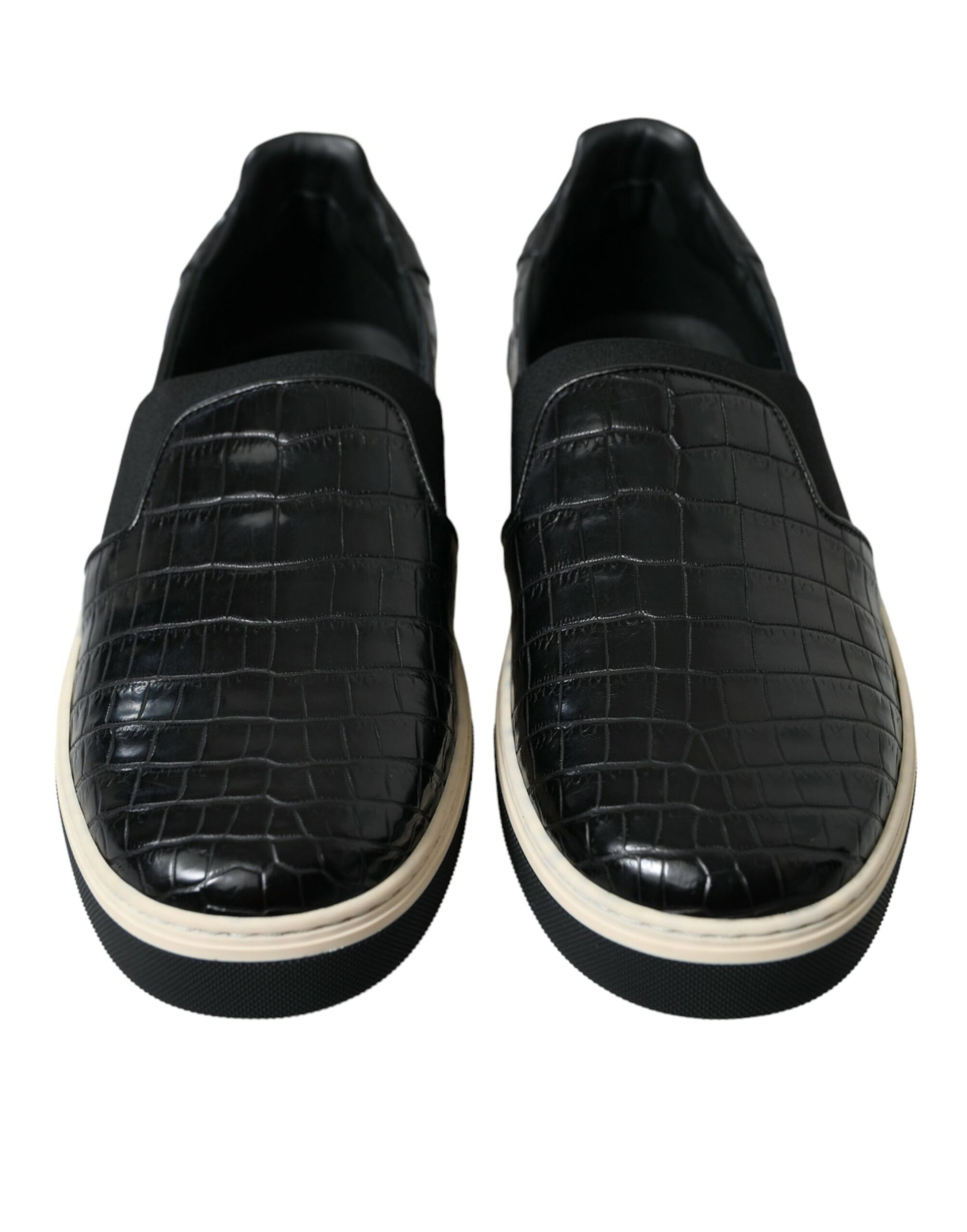 Pair of black shoes with white soles and a crocodile skin texture on the upper part