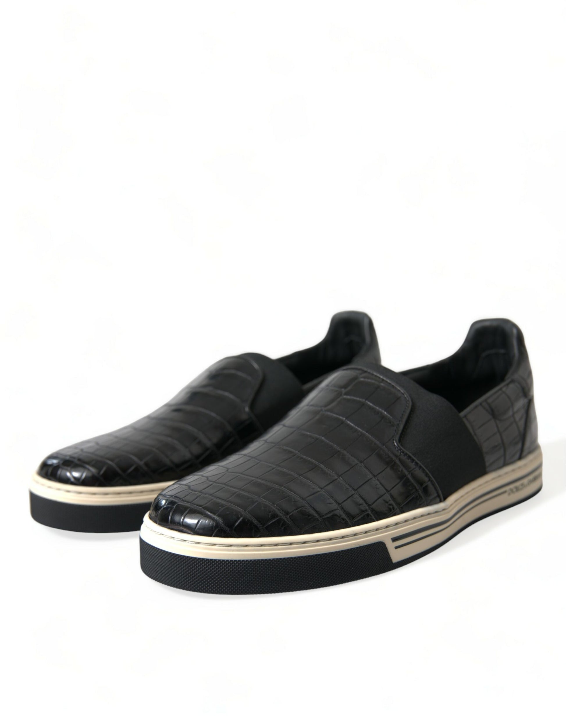 Pair of black sneakers with white soles and laces