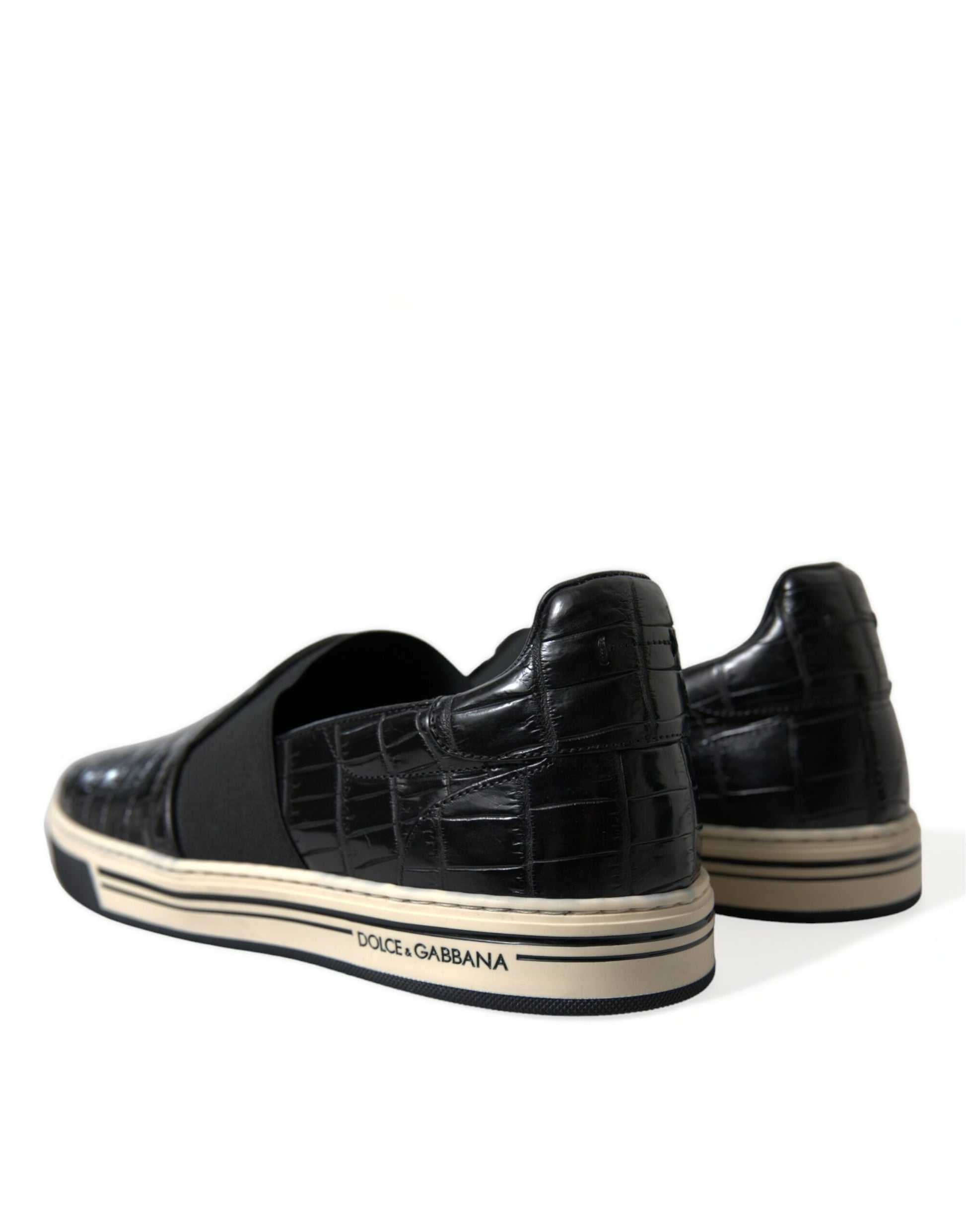 Pair of black sneakers with white soles and laces