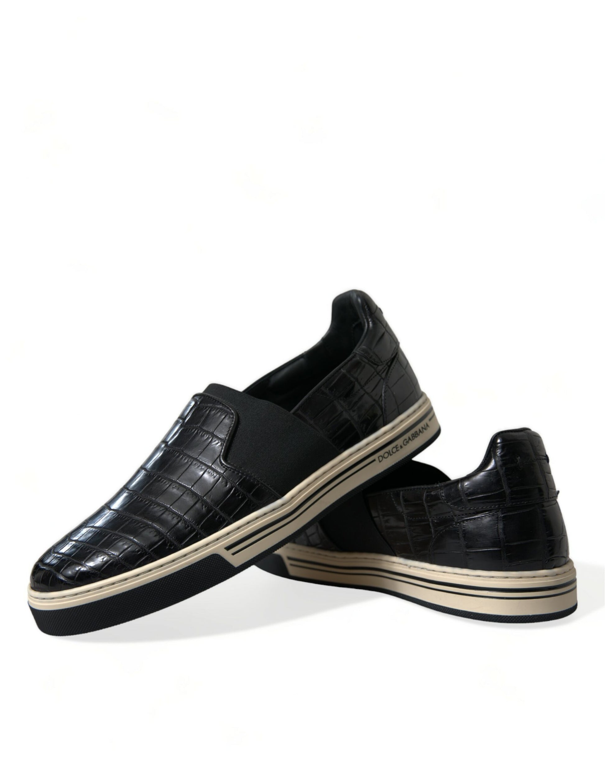 Pair of black loafers with white soles and laces