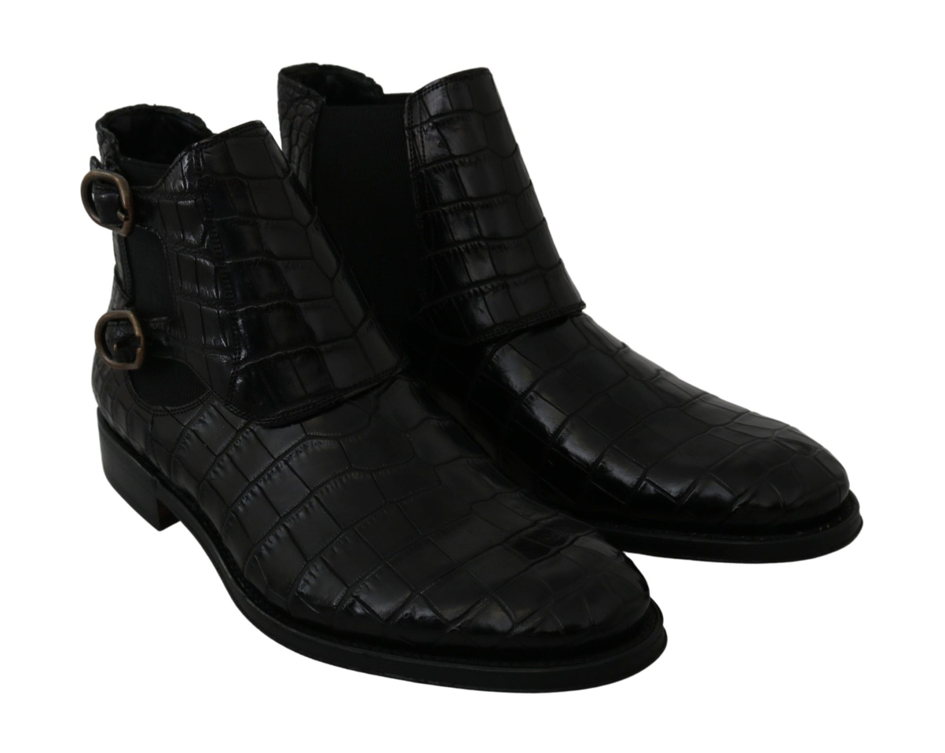 Pair of black leather boots with a quilted design and metal buckles