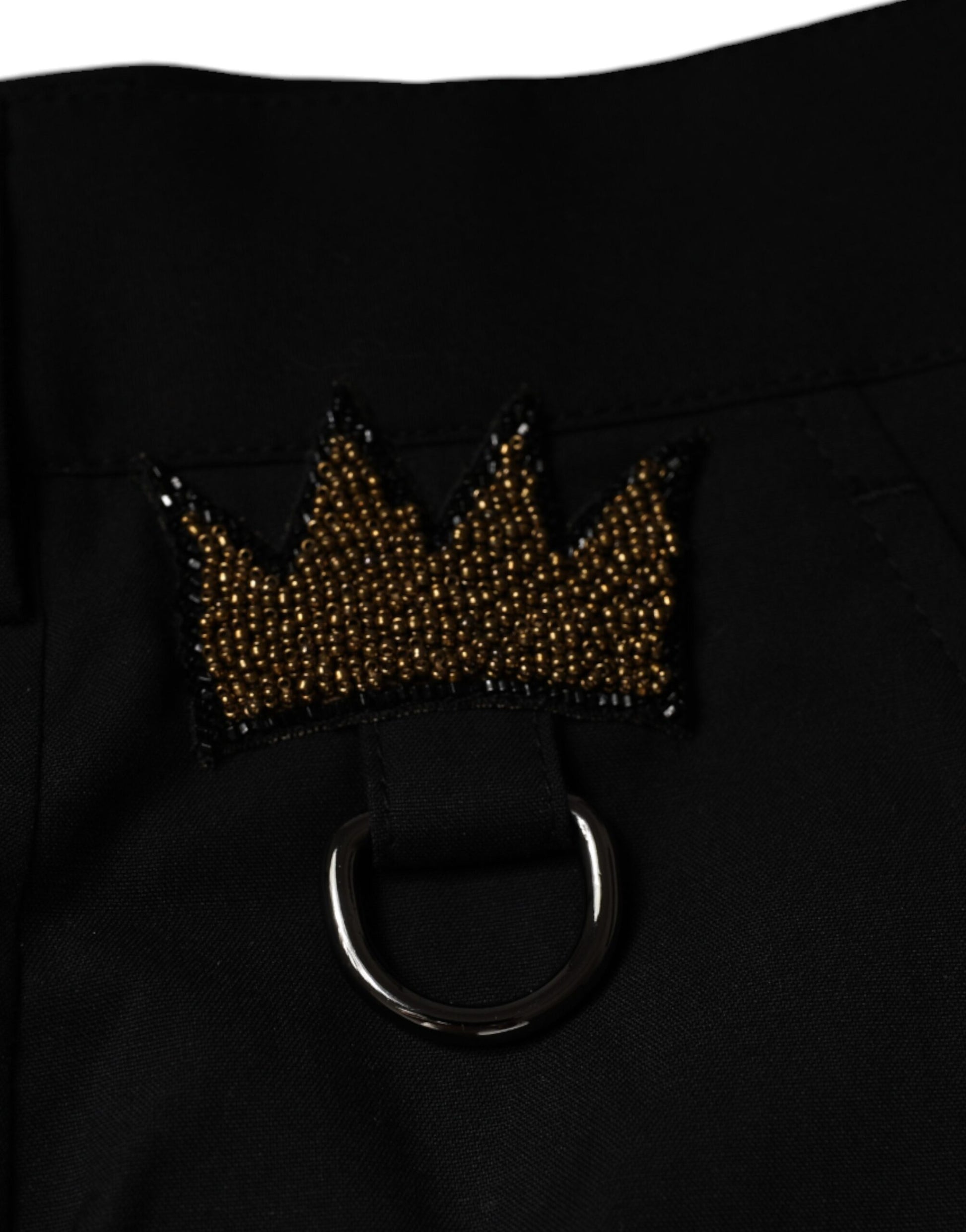 A pair of black cotton dress pants with a crown embroidery on the left side