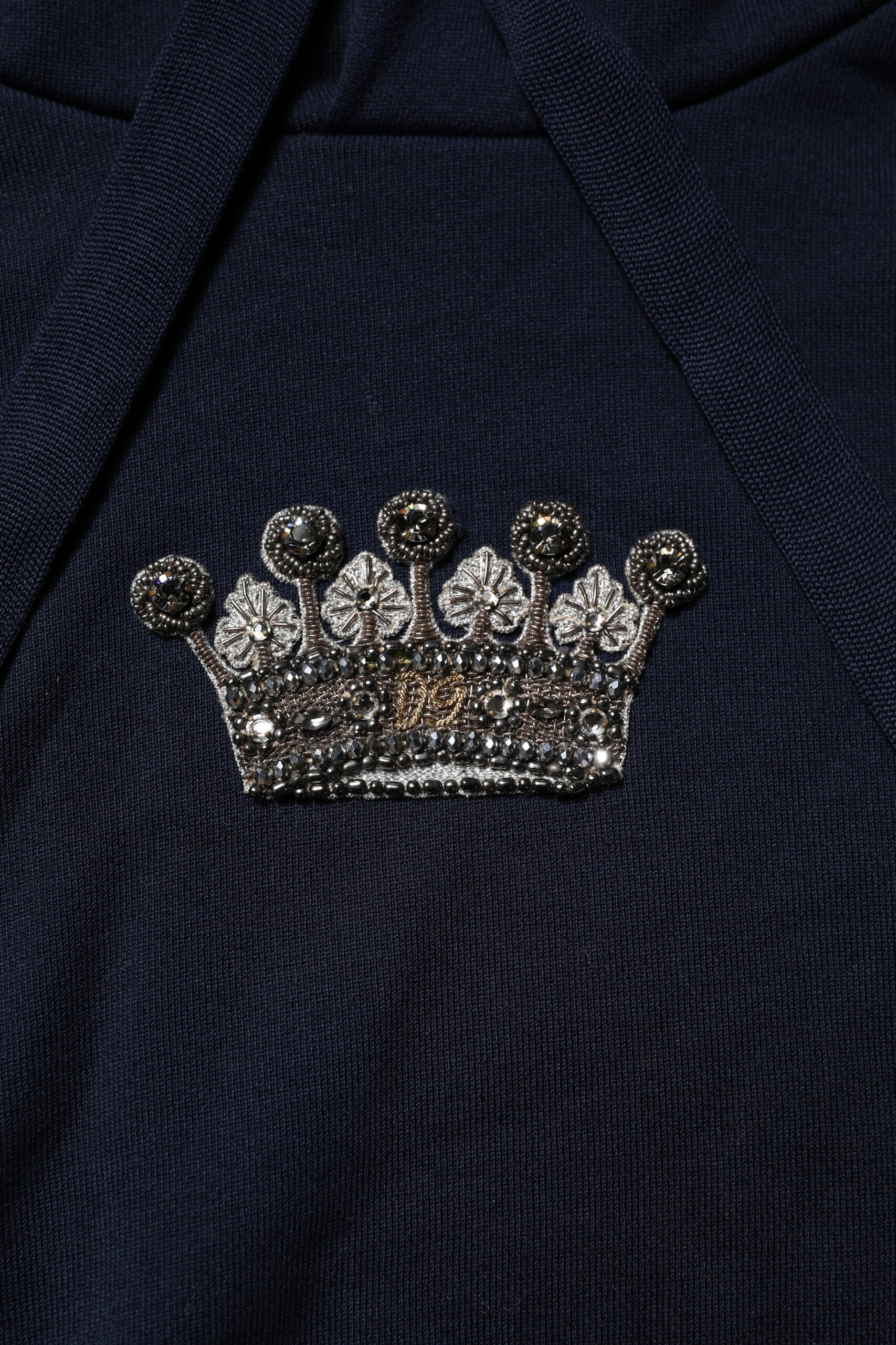 Crown brooch on blue fabric