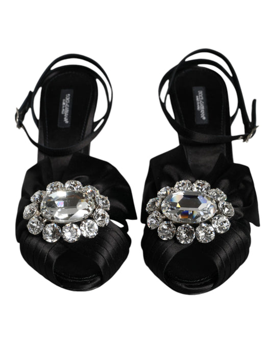 Pair of black high heel shoes with large clear gemstones on top