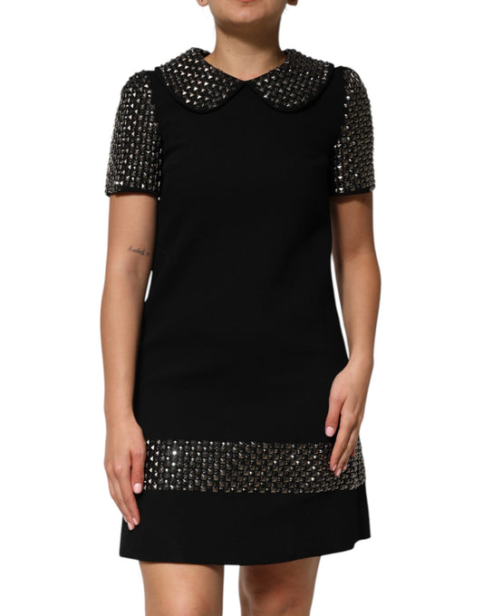 A black dress with crystal embellishments and a collar, from the brand Dolce & Gabbana