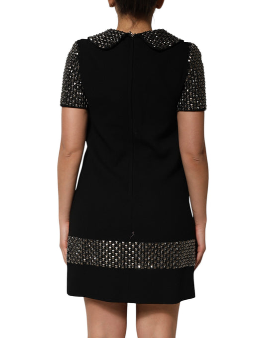 A black dress with crystal embellishments on the front and collar