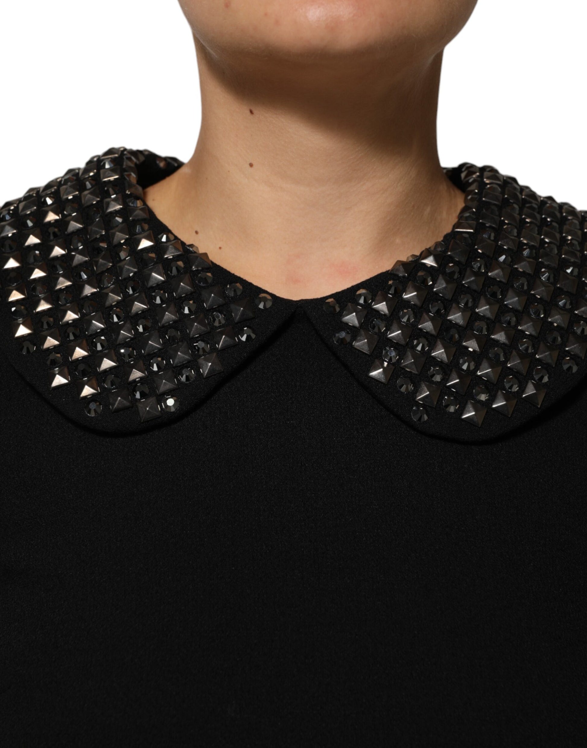A black dress with crystal embellishments on the collar and shoulders