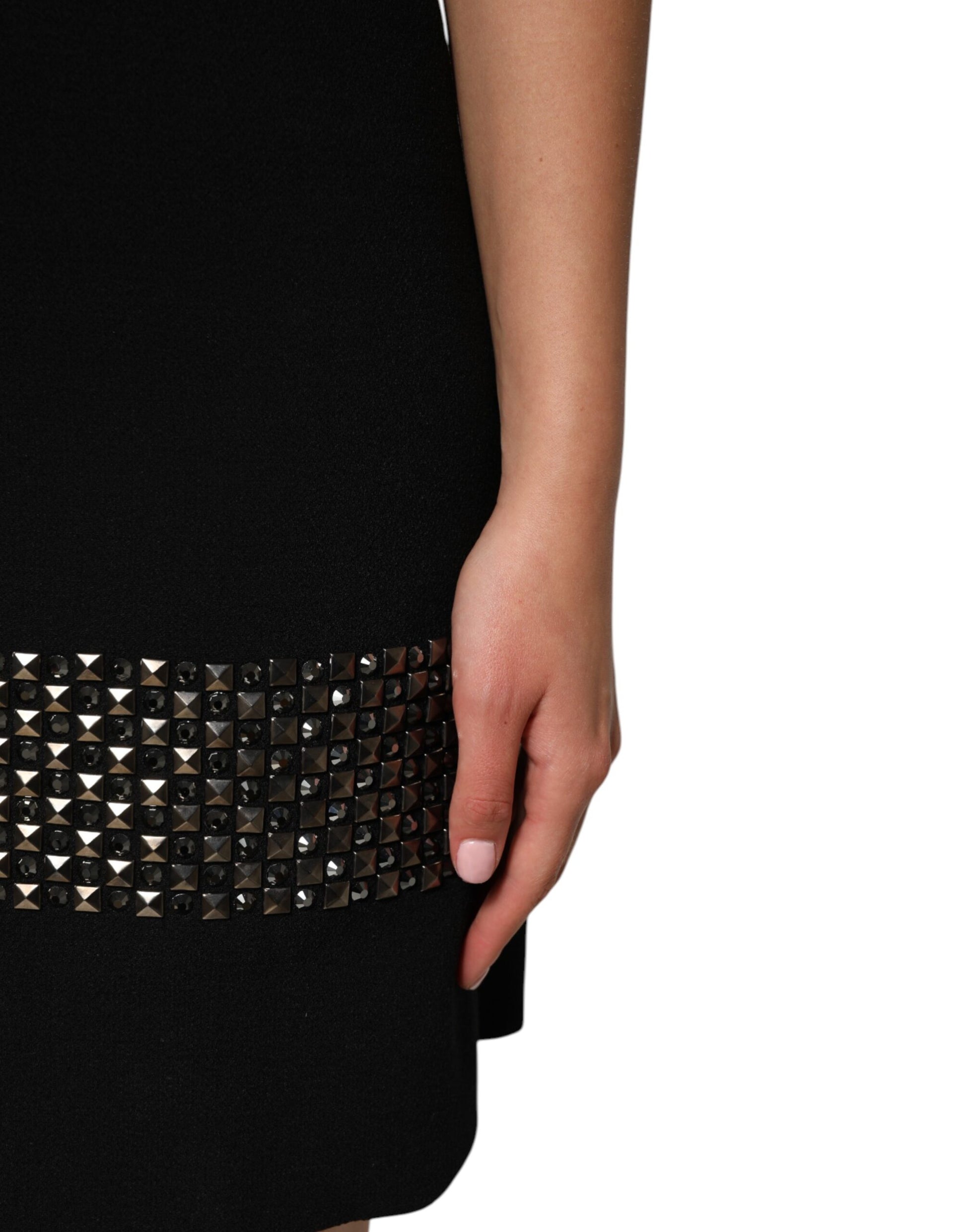 A black dress with crystal embellishments on the waist and collar