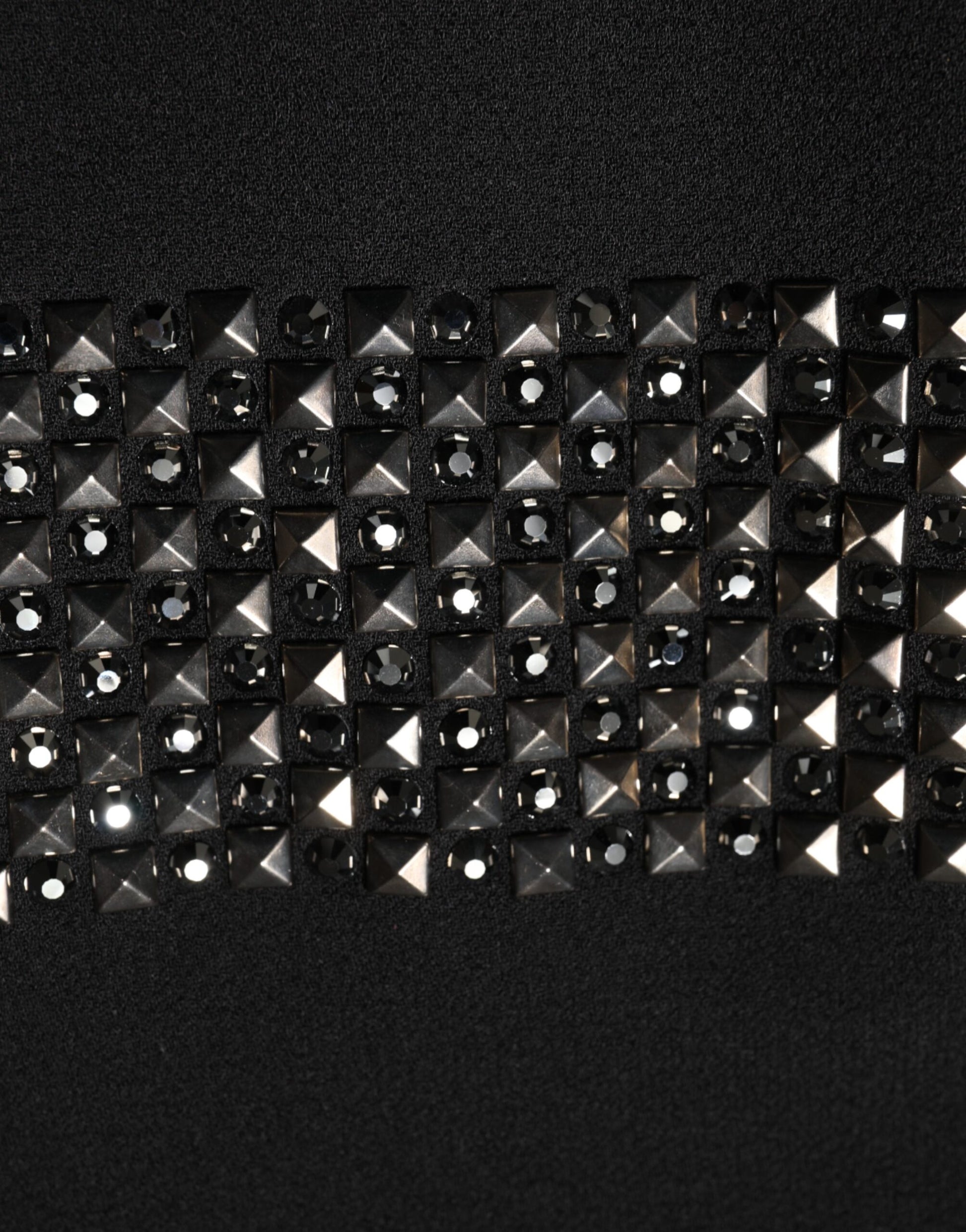 A black dress with crystal embellishments on the collar and sleeves