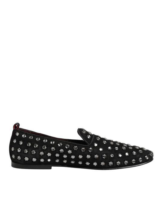 A pair of black loafers with crystal embellishments, featuring a pointed toe and elastic panels for comfort