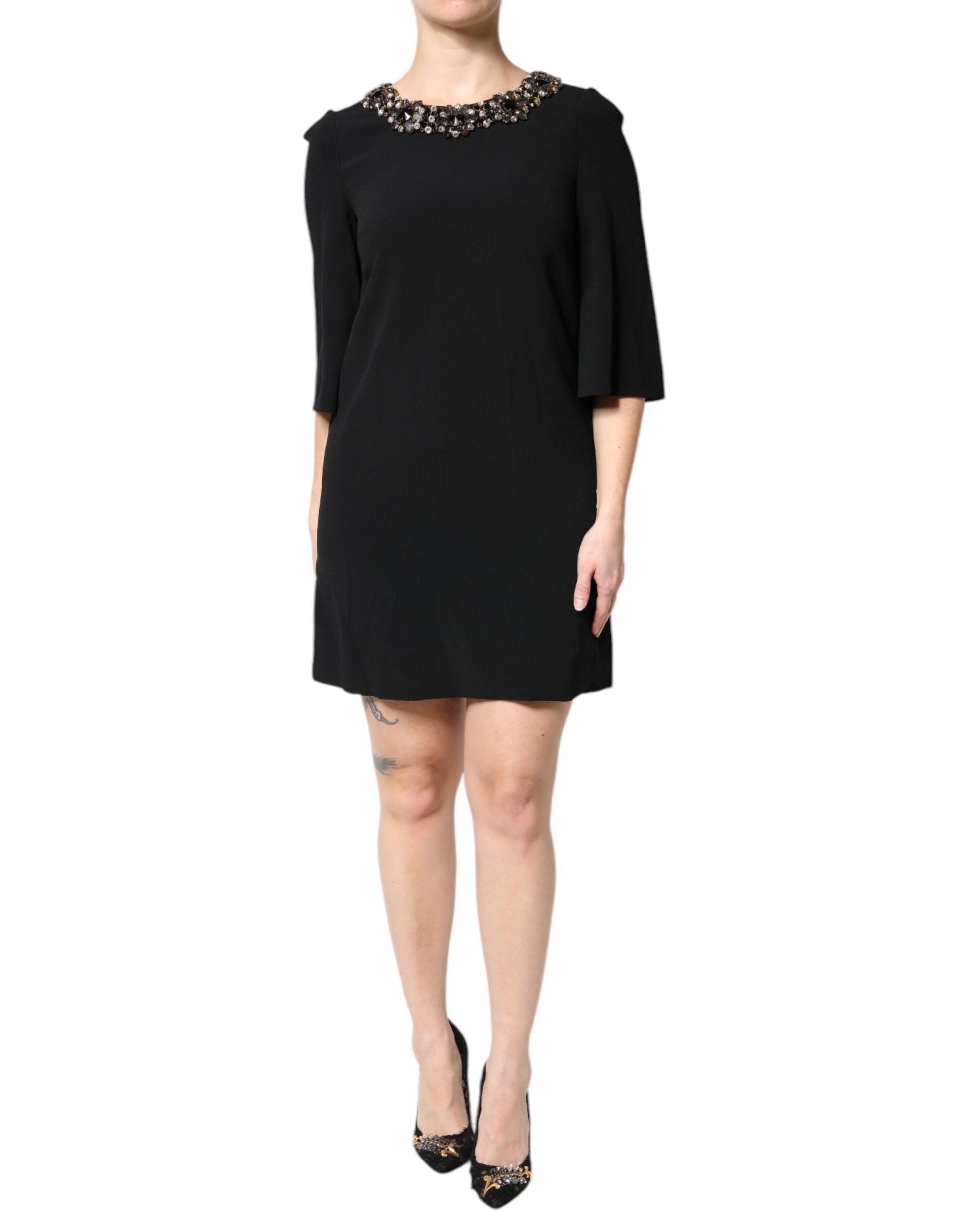 A black dress with crystal embellishments on the neckline and sleeves