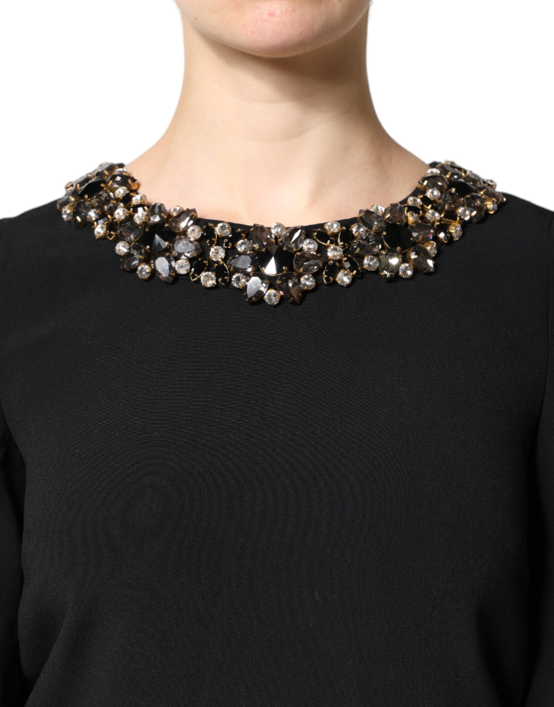 A black dress with a round neckline, featuring crystal embellishments