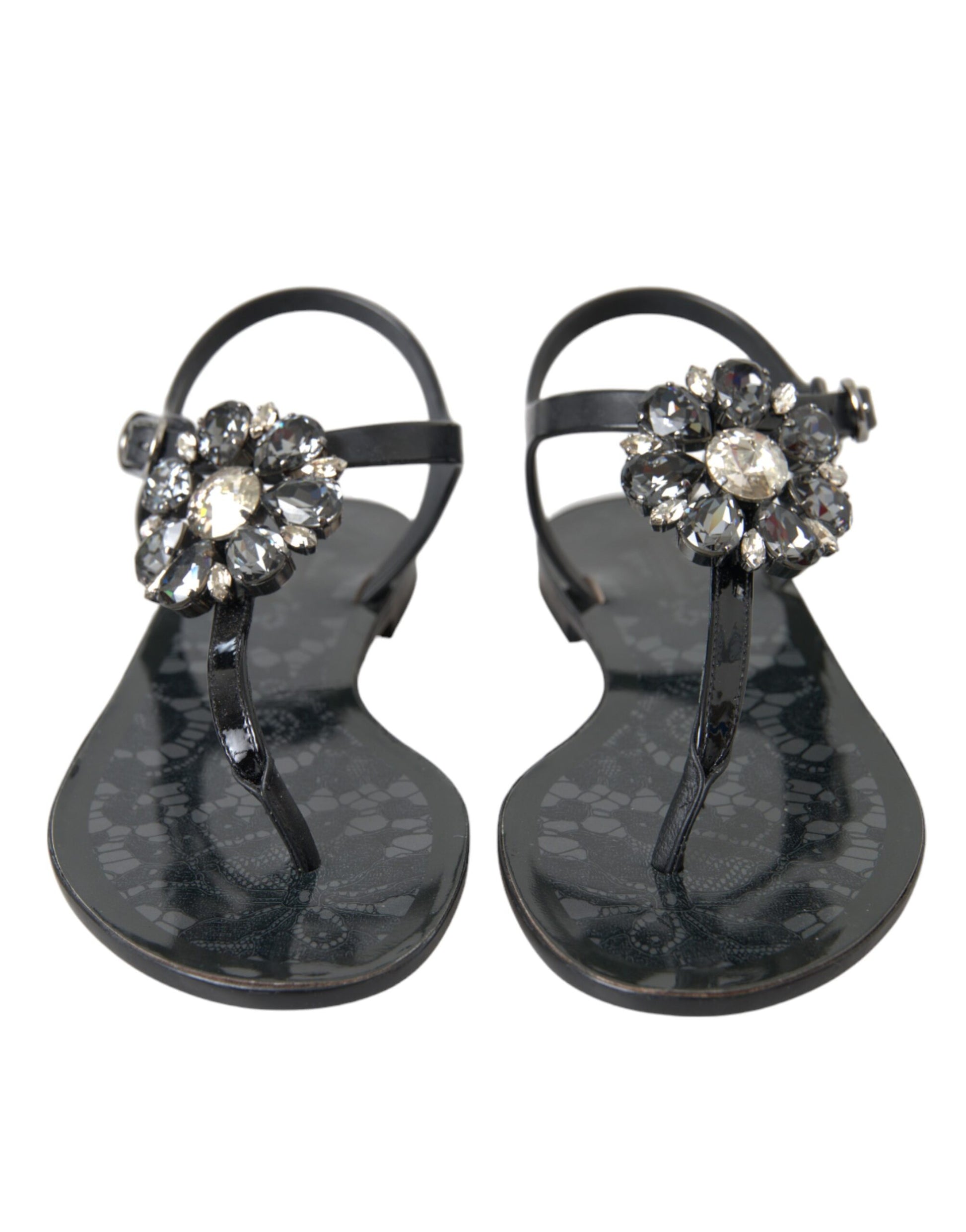Pair of black sandals with rhinestone embellishments on straps