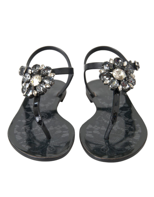 Pair of black sandals with rhinestone embellishments on straps