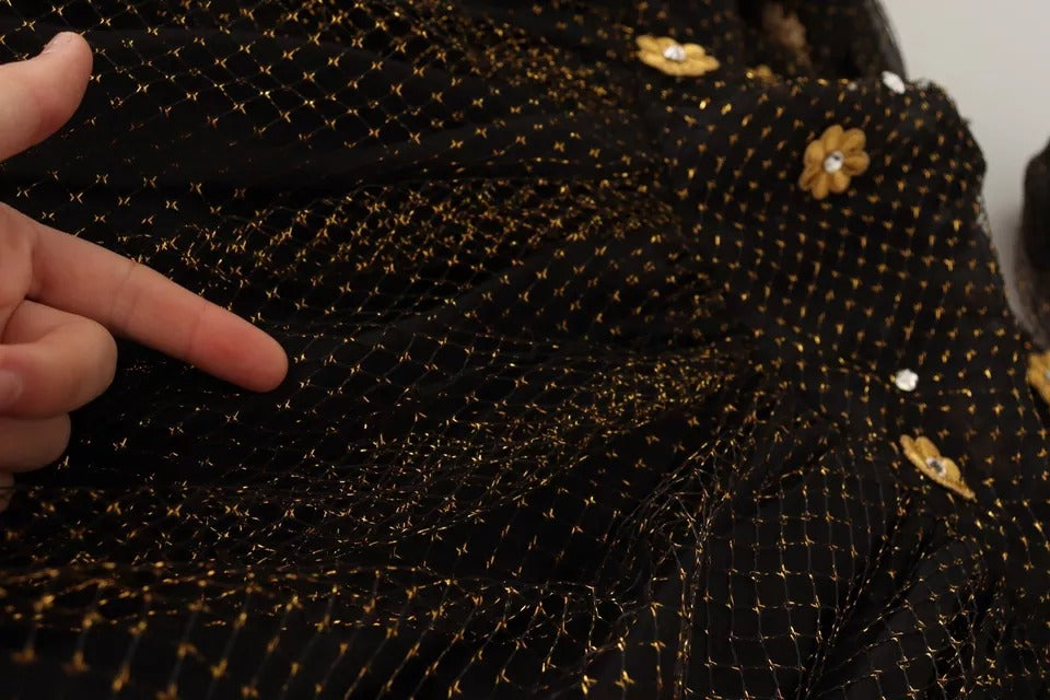 A black dress with gold crystals and floral pattern, featuring a long skirt