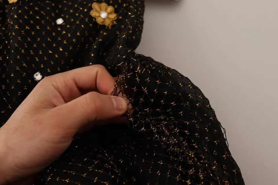Hand sewing sequins onto a black crystal floral maxi ball gown dress