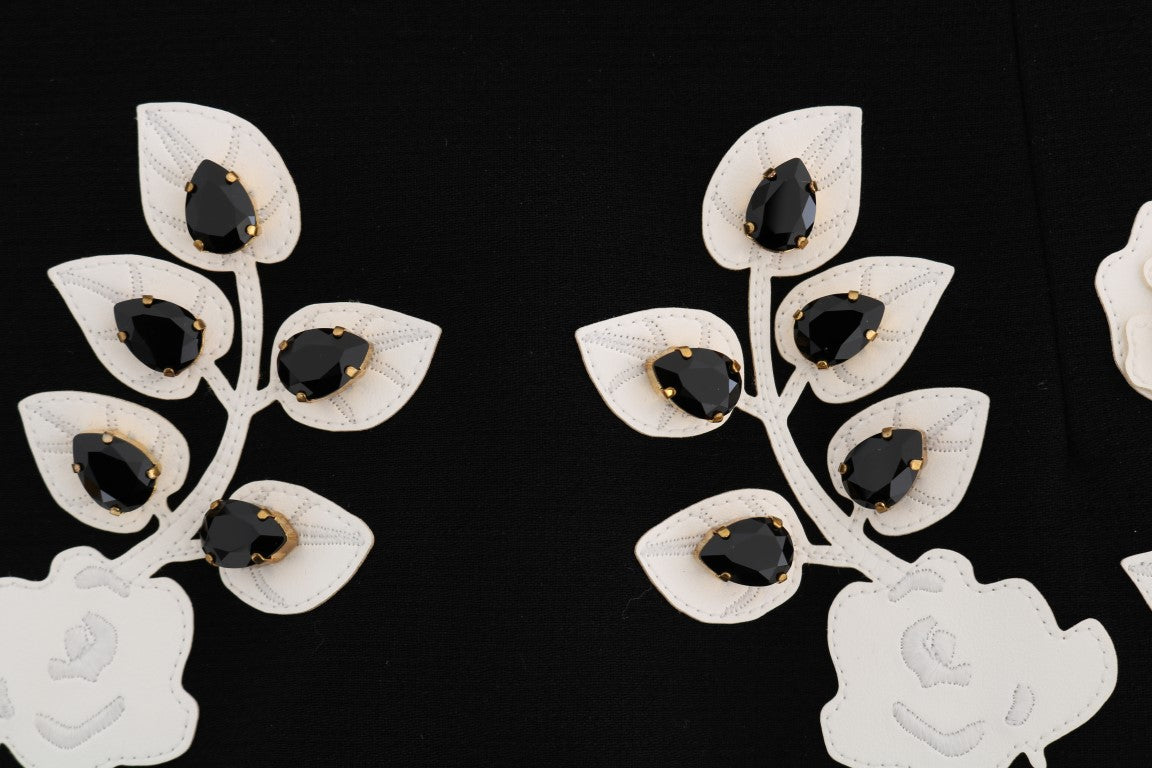 Decorative earrings with black stones on a black background