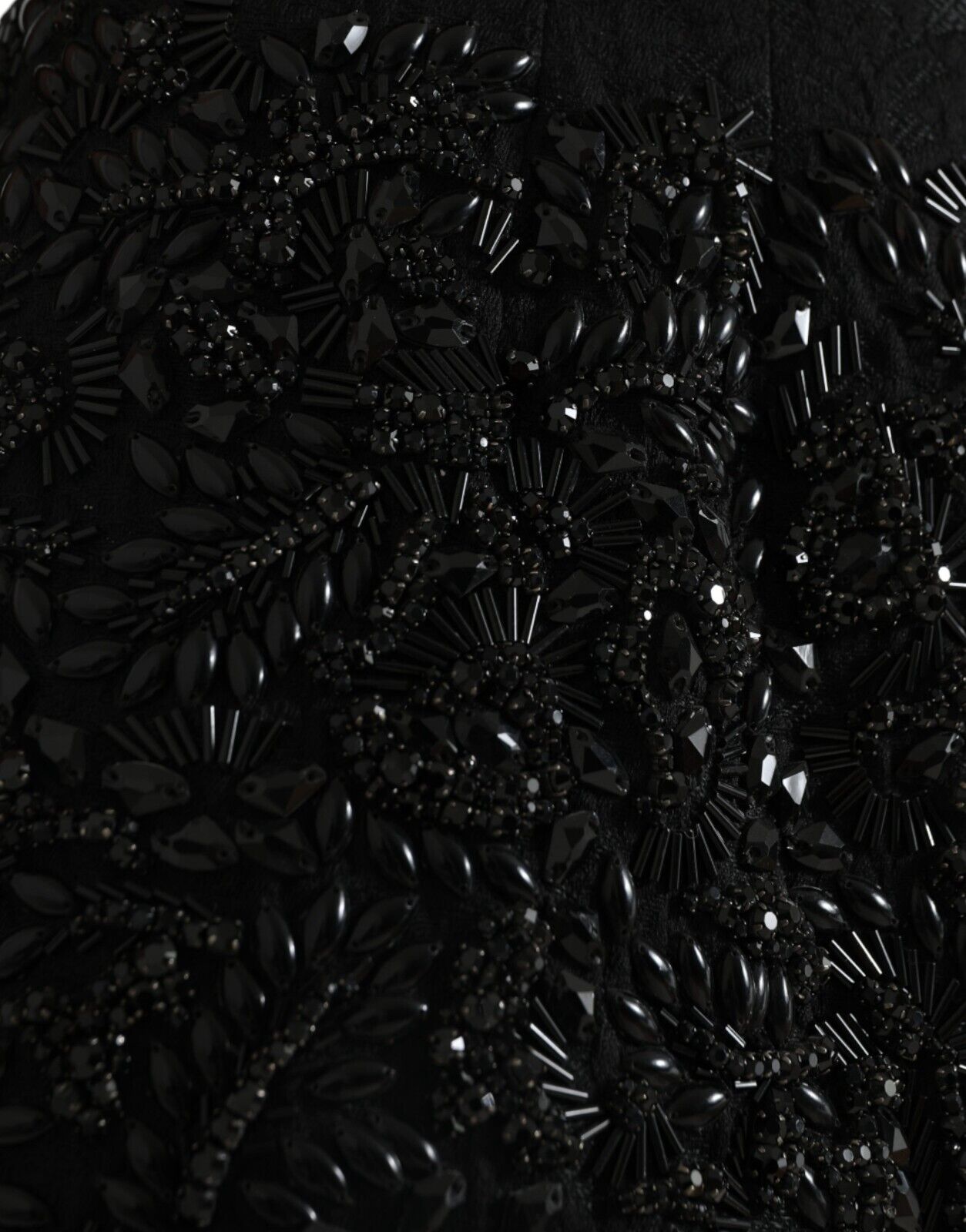 Black sequined garment with intricate design