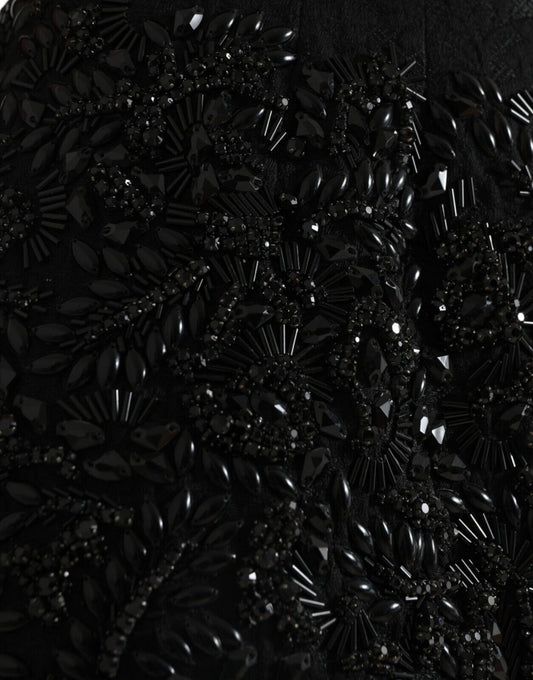 Black sequined garment with intricate design