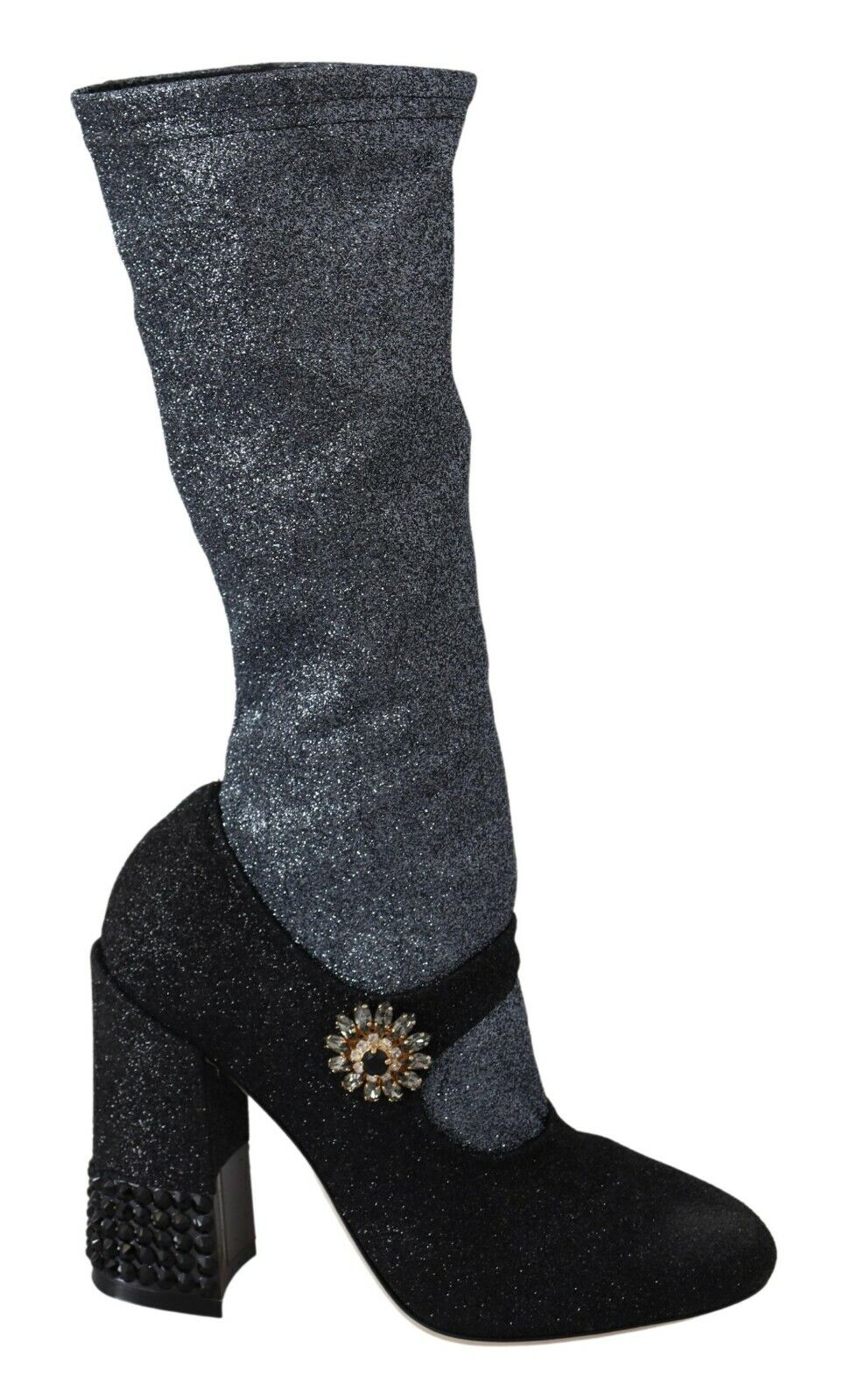 Glittery knee high boots with a stiletto heel and a bow on top of the boot