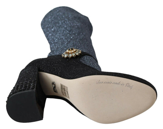 Black glittery boot with a gold buckle and writing on the sole