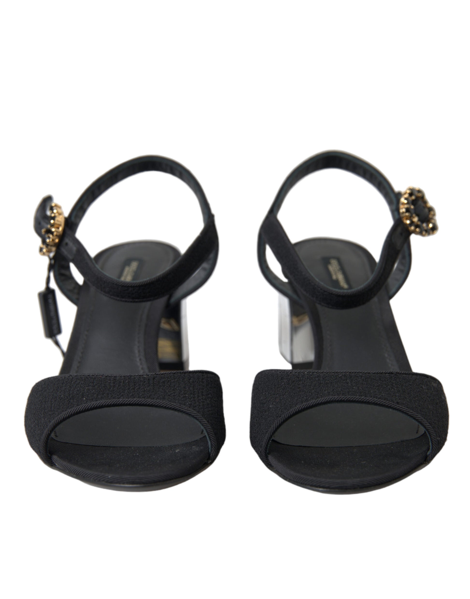 Pair of black strappy heels with gold accents and a bow on top