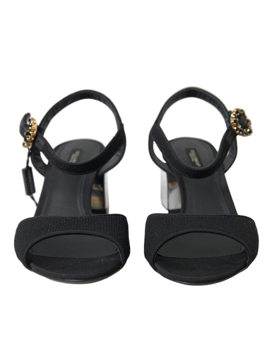 Pair of black strappy heels with gold accents and a bow on top