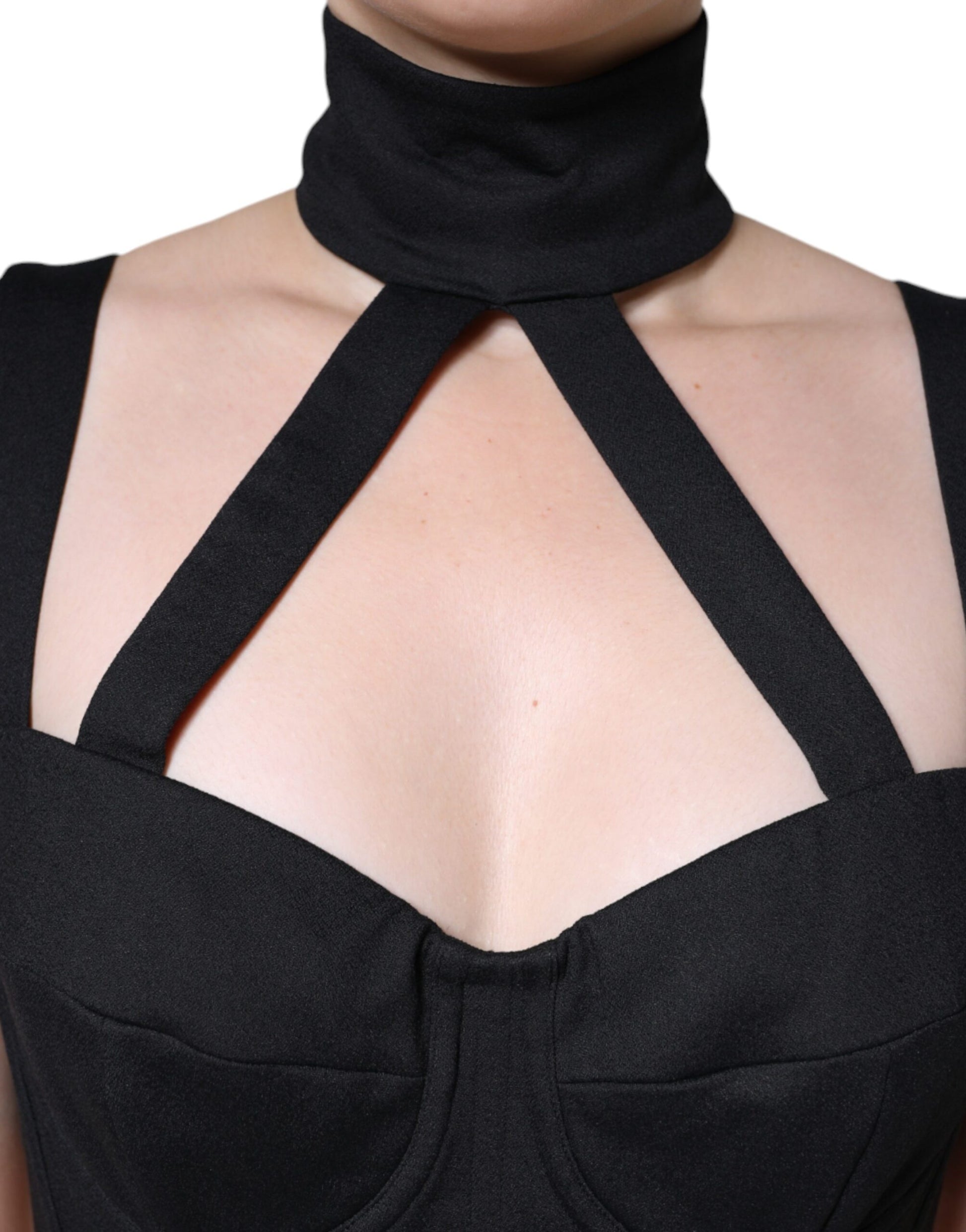 A black cut out sleeveless bodycon mini dress with a high neckline