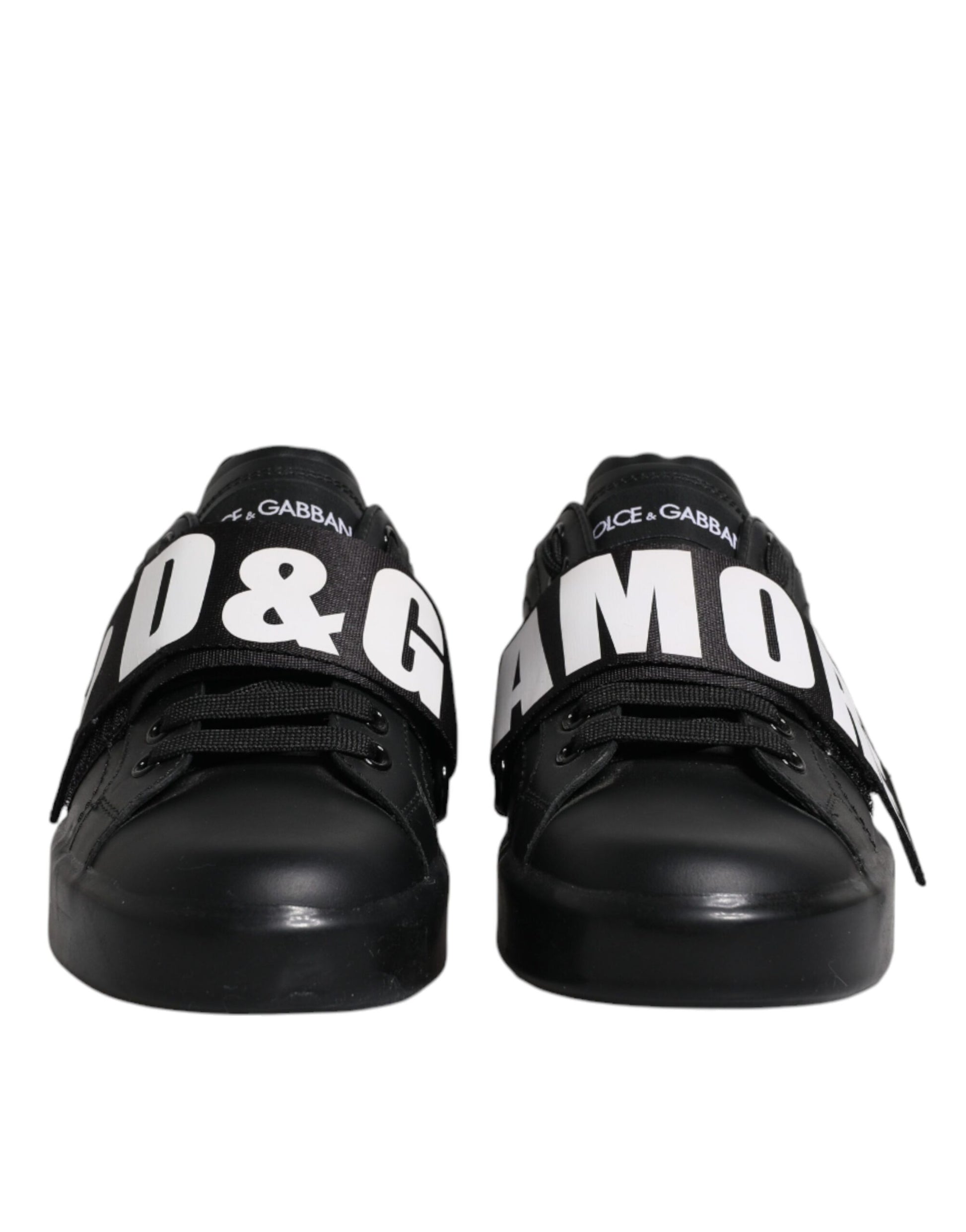 Pair of black sneakers with white lettering on sides