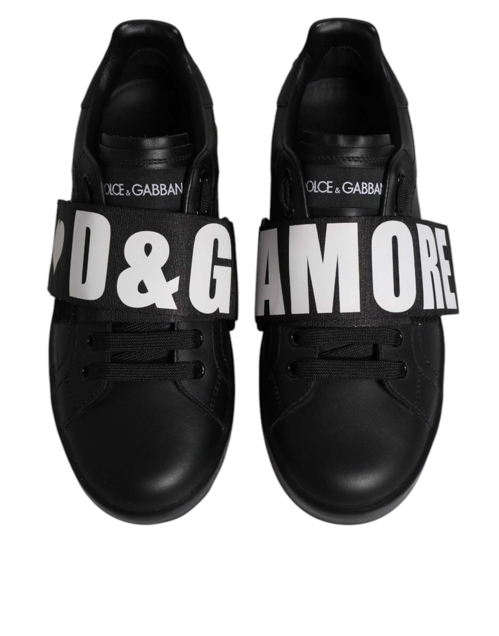 Pair of black sneakers with white branding and laces