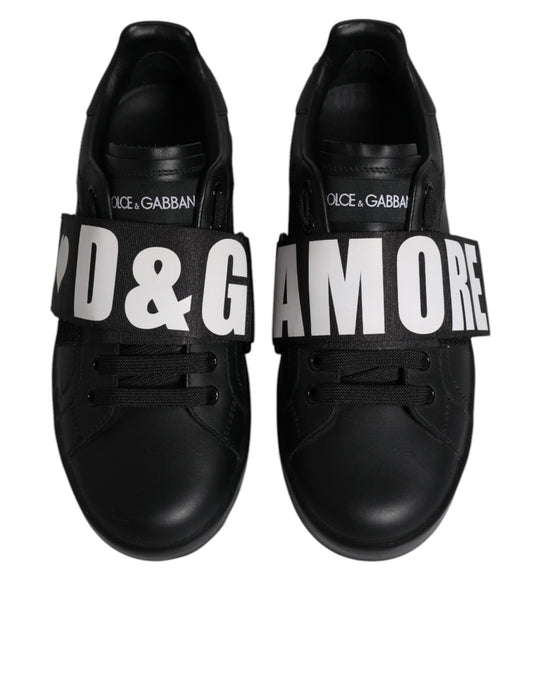 Pair of black sneakers with white branding and laces