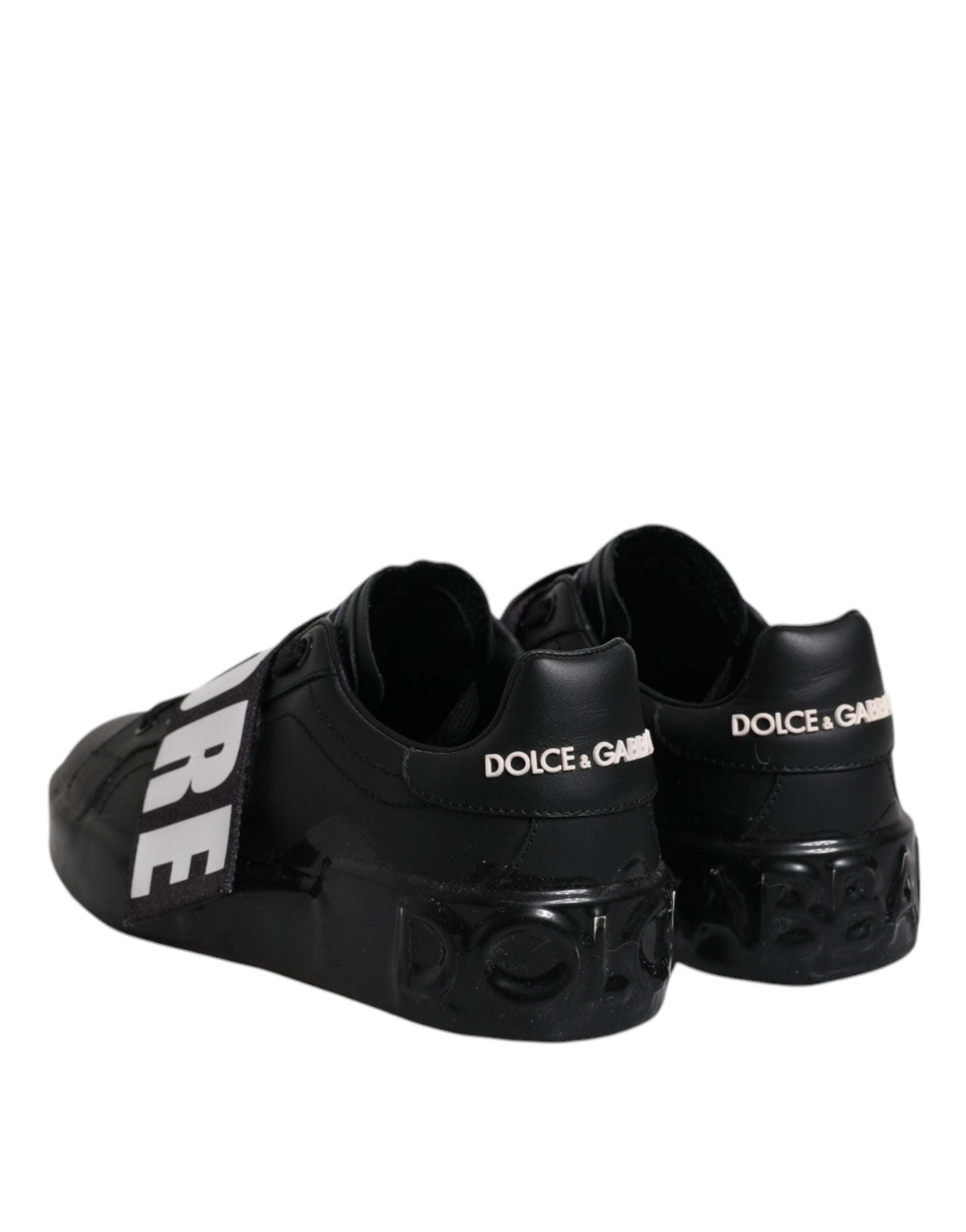 Pair of black sneakers with white text and logo
