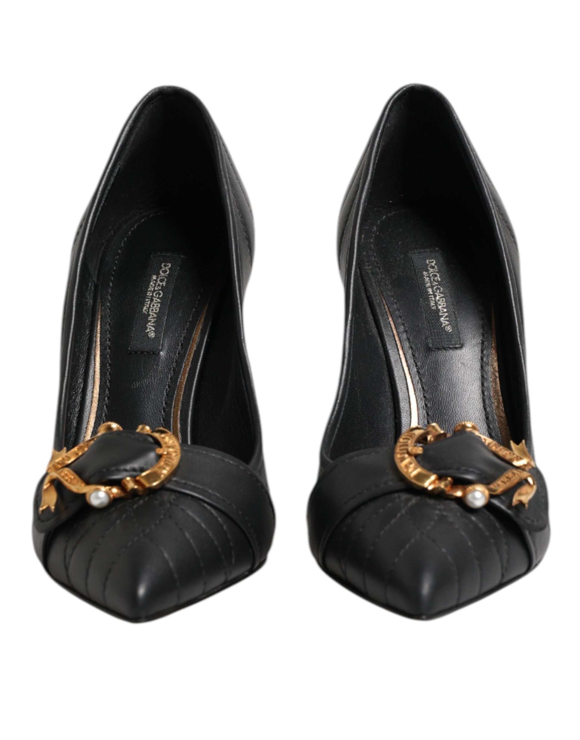 Pair of black high heel shoes with gold accents