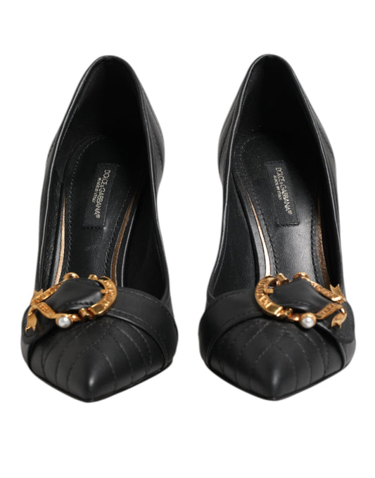 Pair of black high heel shoes with gold accents