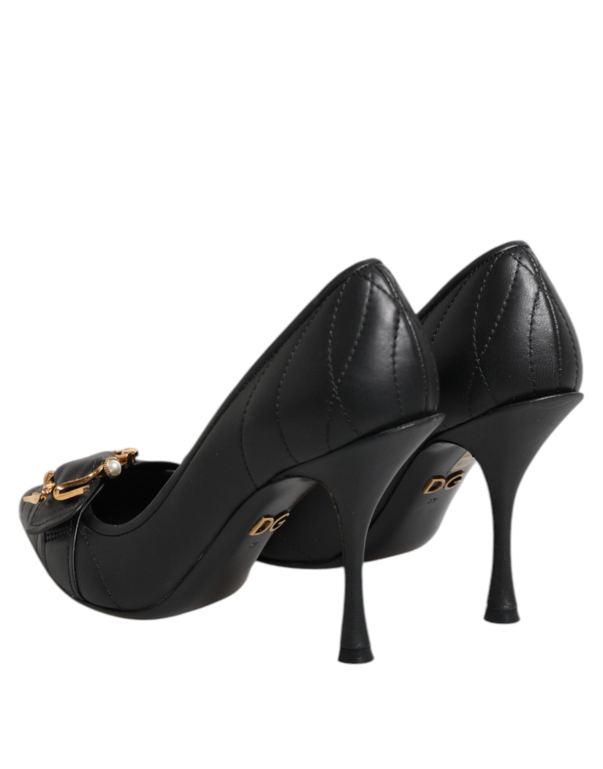 Pair of black high heel shoes with gold accents