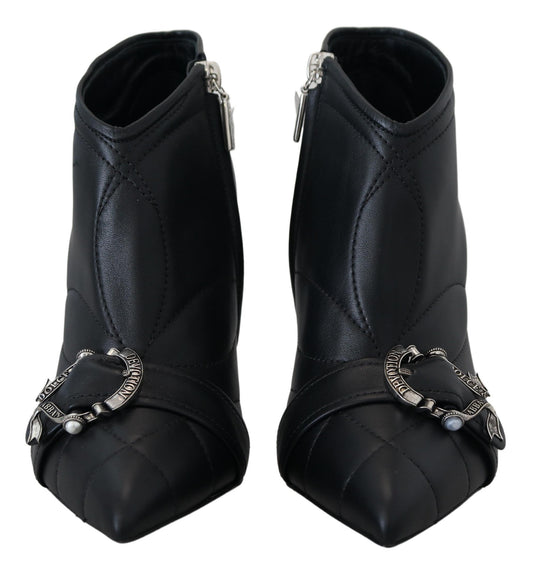 Pair of black leather boots with silver buckles and straps